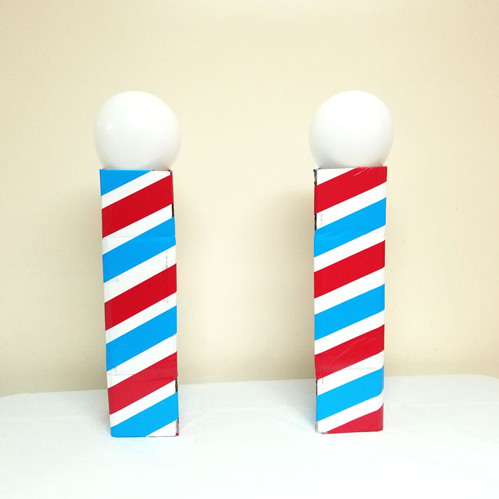 Make this barber shop pole centerpiece for you haircut party! This cool barber shop party decor idea is easy to make, mess-free, and uses recycled materials and is a great, easy upcycled cardboard box craft idea!