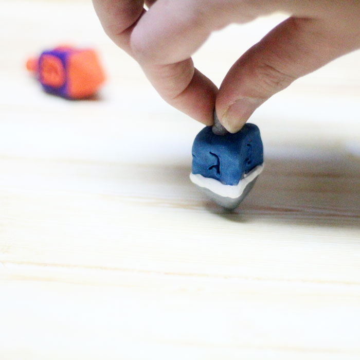 How to make a dreidel out of clay a perfect craft for Hanukkah! You can totally do these as a chanukah party activity since they don't take too long to bake and make a cool gift for kids as well.