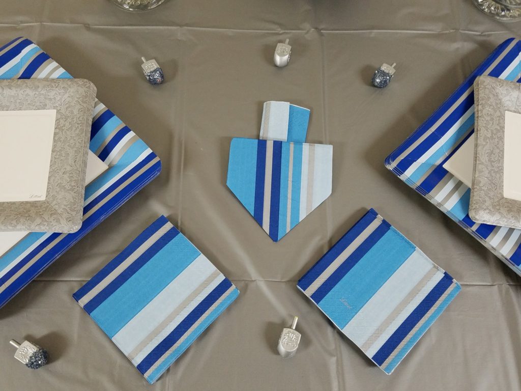 Try this dreidel napkin fold for your Hanukkah celebrations! These DIY dreidel napkins are perfect for your Chanukah party, make great Hanukkah decor and will finish off your tablescape.