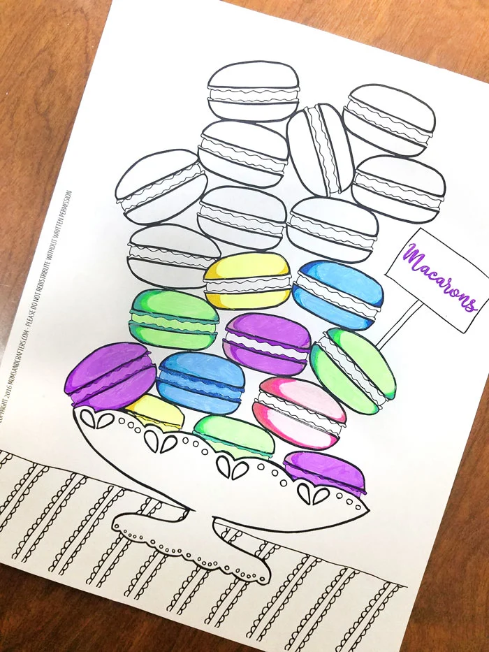 Free Printable coloring pages for adults - get this free food coloring page download for grown-ups! Color these macarons using pretty pastels or however you like them - whatever you do, just don't topple the pile! these are a great activity at a French themed event or to frame and hang as DIY kitchen decor.