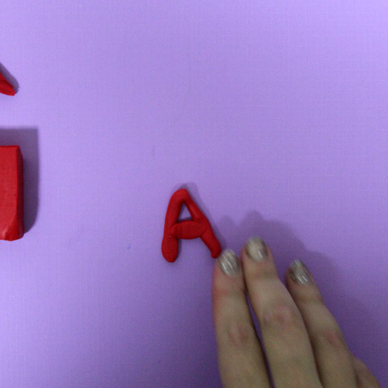 Make these fun DIY alphabet magnets using clay - love this DIY gift idea for young children! IT's a great way to teach the abc's and perfect for preschoolers. The glossy finish makes it look great.