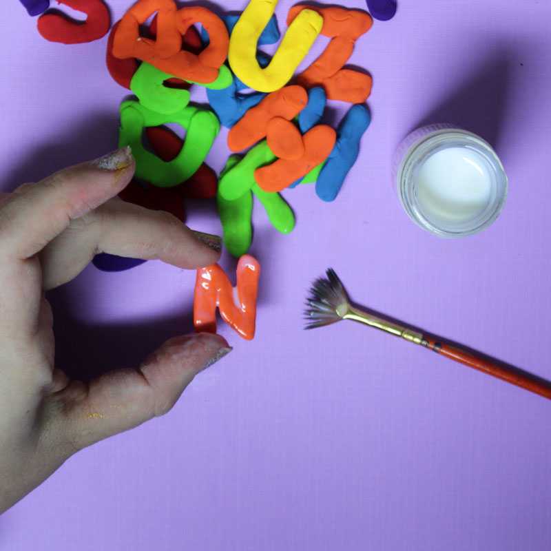 Make these fun DIY alphabet magnets using clay - love this DIY gift idea for young children! IT's a great way to teach the abc's and perfect for preschoolers. The glossy finish makes it look great.