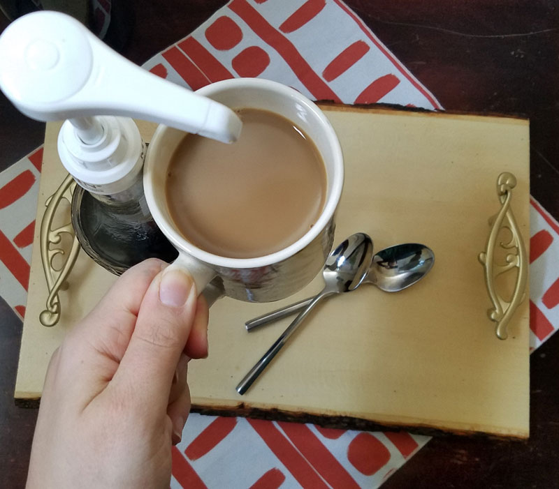 Make this beautiful rustic and easy DIY coffee bar tray - it' super easy! It's great for setting up a coffee bar in the kitchen or a flavoring station at a party or a wedding, and corrals syrups and flavorings in a small space. It has a farmhouse style to it, with a bit of glam added in - just choose the handles to suit your decor!