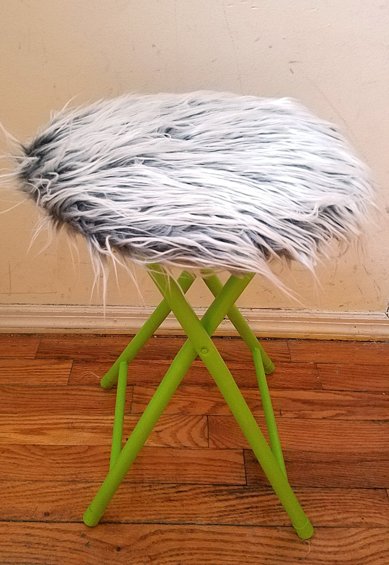 This fur stool makeover has IMPACT! It took me about half an hour including drying time... it's an easy DIY bar stool makeover that was done on a metal stool but works on wooden stools too. It's great for craft room or a teen girl's bedroom decor idea, use a round stool to sit, dress, or even as a night stand!