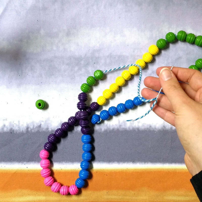 Make a super easy DIY trivet using wooden beads! This large coaster takes five minutes to make, can be made by young kids too, making it a practical kid-made gift idea. It's also durable and the wooden beads makes this wooden trivet really work to protect your surface! Perfect mother's day gift, or to make for yourself.