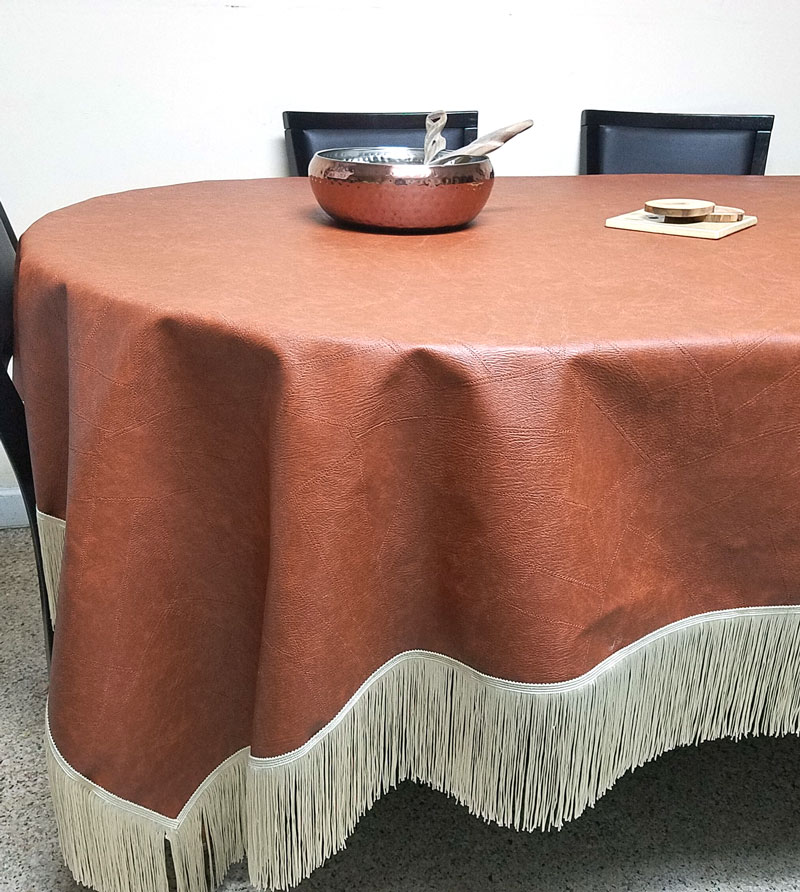 A faux leather table cloth - how brilliant is that?! Make this super easy no sew DIY leatherette tablecloth so your kids don't mess up your good one. It doesn't look tacky like other vinyl table covers, and is a brilliant holiday tablescape idea or kid-friendly decor!