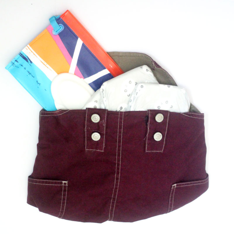 Upcycle old overalls and make this adorable DIY clutch - perfect as a diaper pouch, storage pouch for books, iPad sleeve (or any tablet and device holder) or to contain and protect the library books you're in middle of reading. It's a wounderful eco-friendly recycled beginner sewing crafts and would look just as cute with denim overalls.