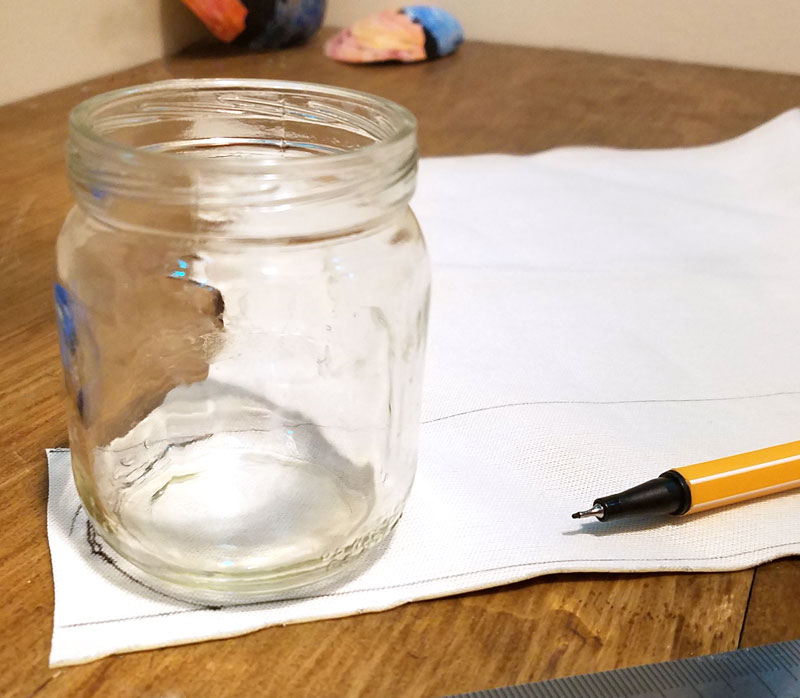 Make a super easy upcycled DIY marker storage caddy to transport the entire family's art supplies from the closet to the table in a usable bin! The jars can be removed individually to easily set up and clean up a family art station with coloring supplies for kids and adults. This recylced cardboard box and jar craft is so easy to make, and is an awesome craft room organization hack.