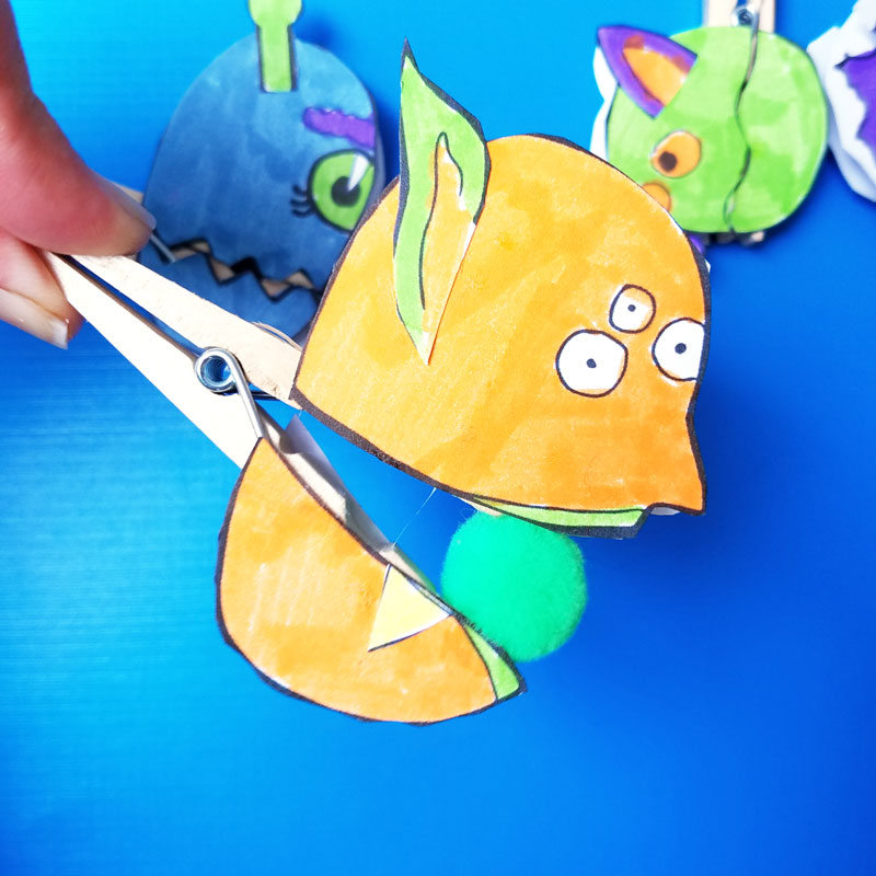 Make these adorable monster clothespin puppets using the free printable template - and then play "Feed the Monster" - a fun fine motor activity and game to help improve pincer grasp! You'll love this paper craft and free printable activity for kids. It's also great for Halloween crafts but fun for year-round too.