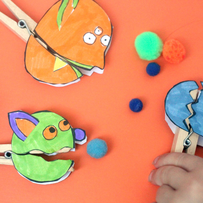 Make these adorable monster clothespin puppets using the free printable template - and then play "Feed the Monster" - a fun fine motor activity and game to help improve pincer grasp! You'll love this paper craft and free printable activity for kids. It's also great for Halloween crafts but fun for year-round too.