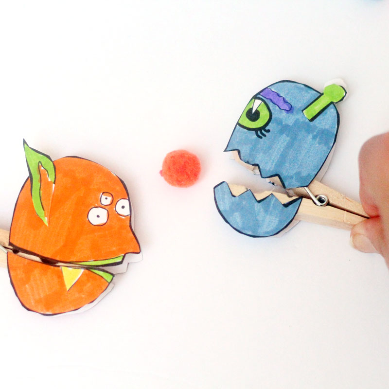 Make these adorable monster clothespin puppets using the free printable template - and then play "Feed the Monster" - a fun fine motor activity and game to help improve pincer grasp! You'll love this paper craft and free printable activity for kids. It's also great for Halloween crafts but fun for year-round too.