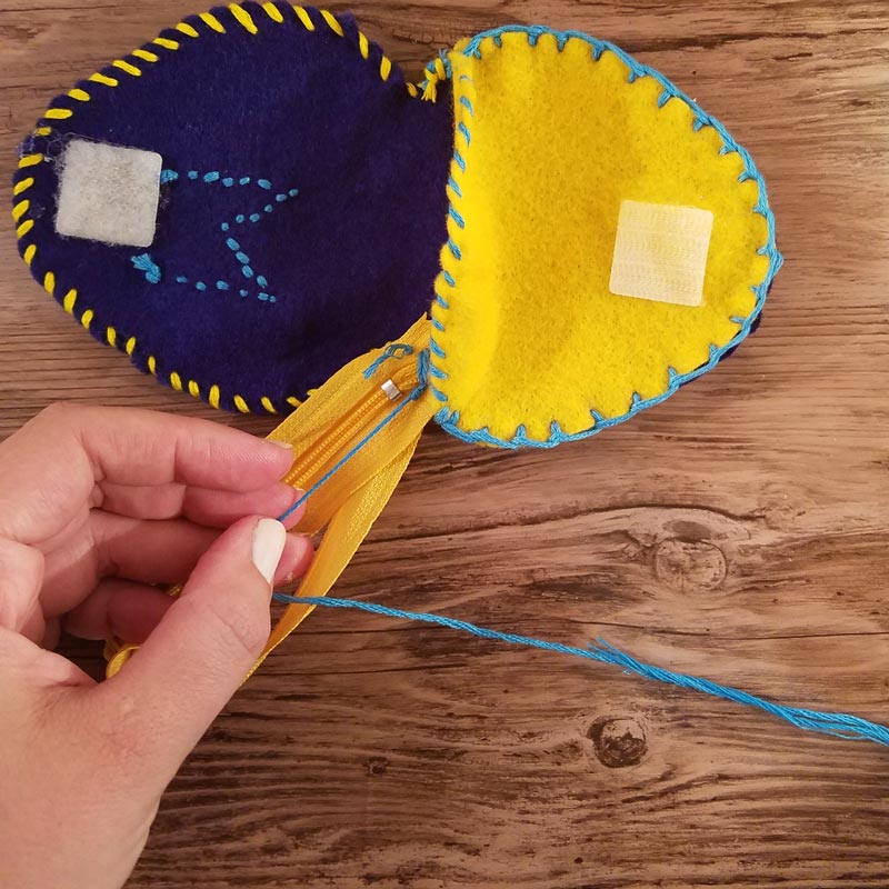 Make this DIY fidget spinner case to protect your fidget toy and keep it a bit farther out of reach of babies! It's an easy beginner felt sewing project that an adult or a child can make, plus it has a built in zipper fidget too! Free template / pattern included.