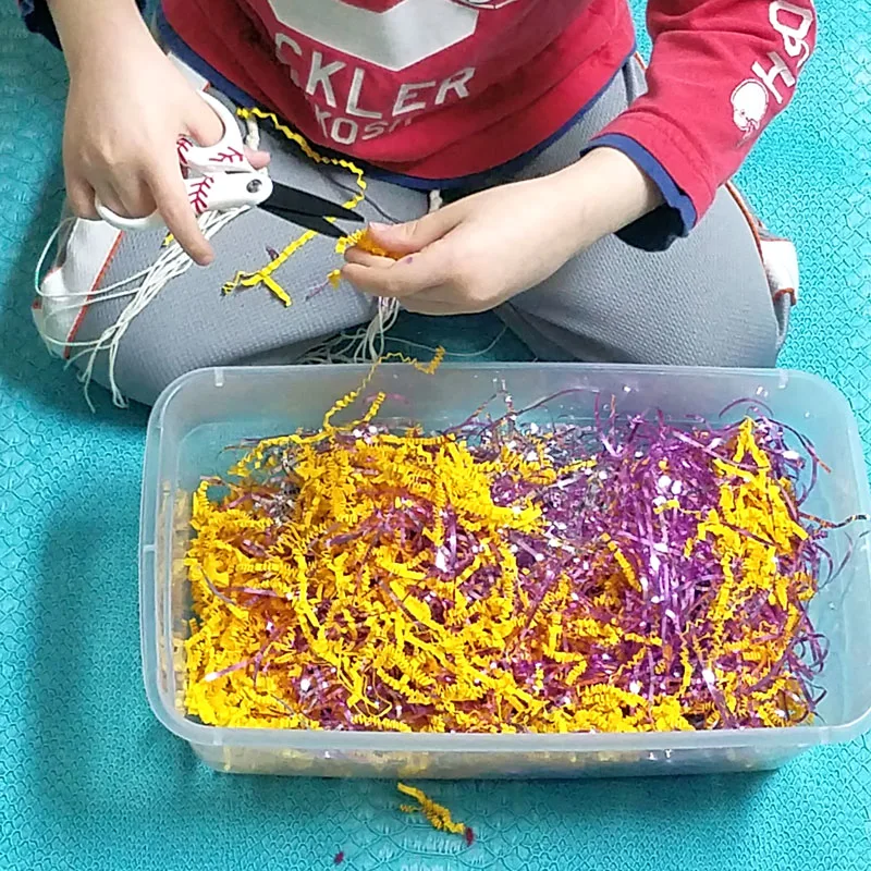 A cutting practice sensory bin that's a perfect way to entertain your preschooler and drink that coffee! This occupational therapy idea and scissors practice activity for preschoolers is perfect for preparing for kindergarten, or just to keep young kids busy.