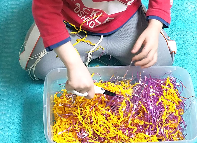 A cutting practice sensory bin that's a perfect way to entertain your preschooler and drink that coffee! This occupational therapy idea and scissors practice activity for preschoolers is perfect for preparing for kindergarten, or just to keep young kids busy.