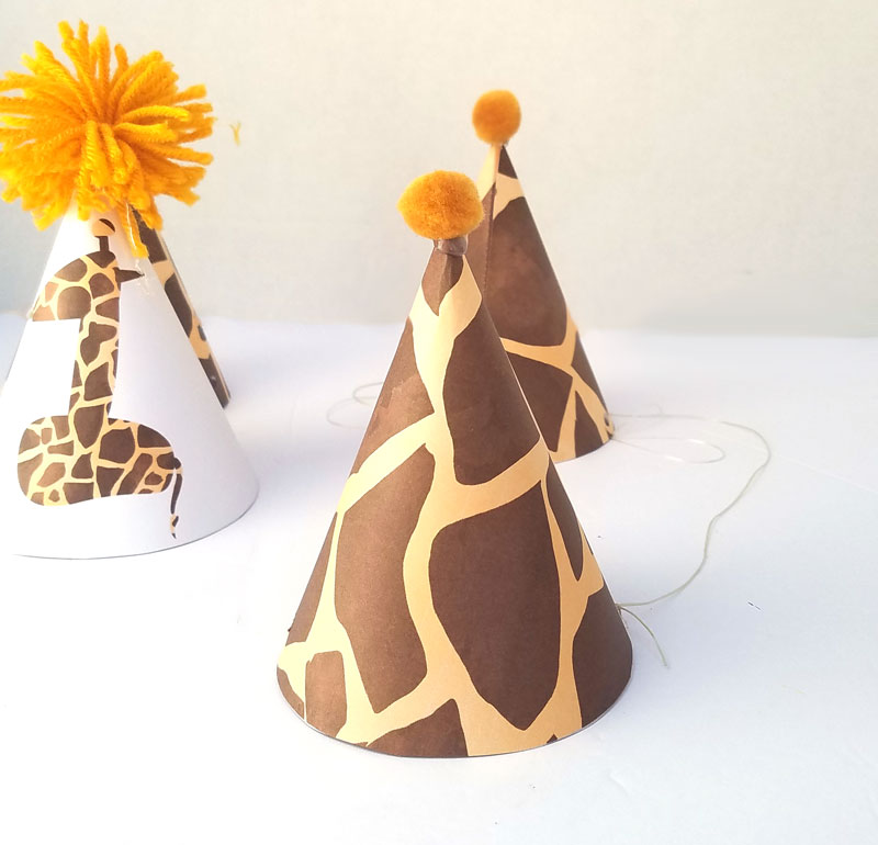 You'll love this giraffe birthday hat - including a free printable version! It's perfect for your giraffe birthday theme, or a jugle themed birthday party, or even a safari theme! It also includes a fun idea for a first birthday party theme for boys.