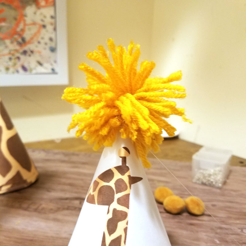 You'll love this giraffe birthday hat - including a free printable version! It's perfect for your giraffe birthday theme, or a jugle themed birthday party, or even a safari theme! It also includes a fun idea for a first birthday party theme for boys.