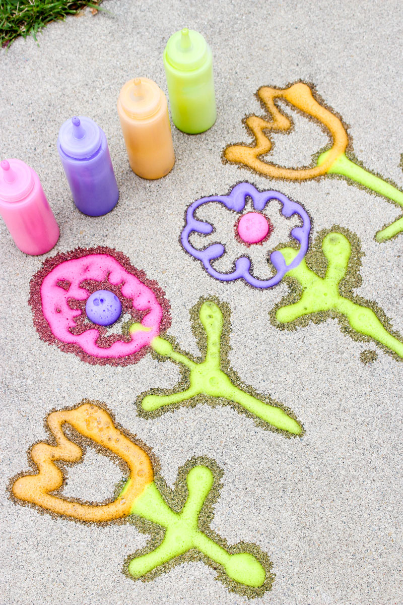 Make super easy foamy sidewalk paint - an awesome liquid sidewalk chalk recipe that's perfect for cold weather too! This outdoor art activity for kids is super easy and inexpensive, can be done in the winter, can be used to paint snow, can be carried over as a spring or summer activity too - basically, you can do anything with it!