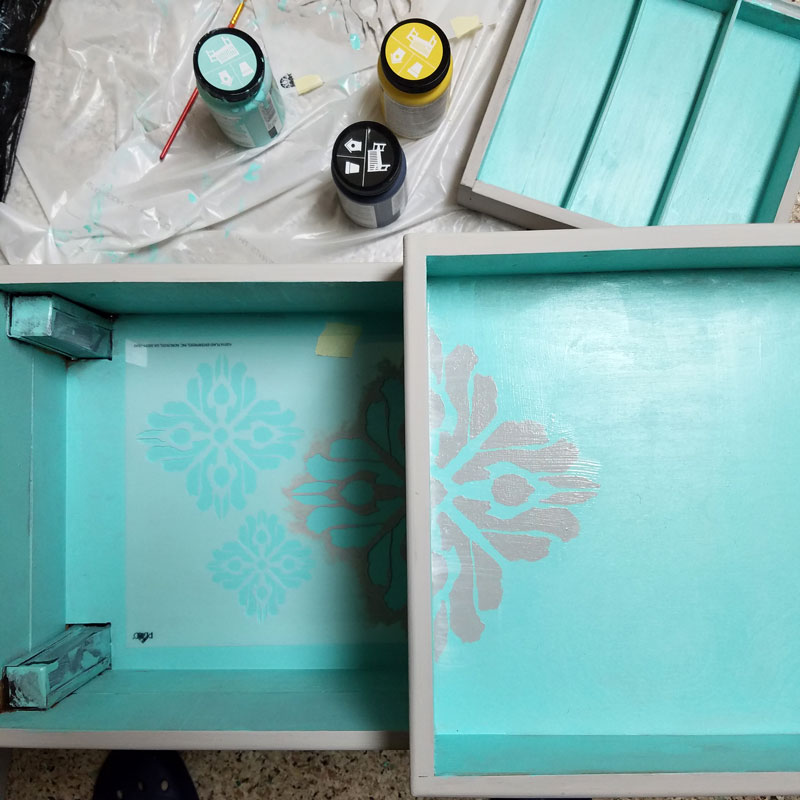 Open up for a cool surprise! Update a vintage sewing box with this cool DIY makeover using stencils. The top says "create" and there are beautiful patterns inside - you simply won't believe that this was a flea market find! One of my favorite thrift store makeovers and trash to treasure DIY projects ever, and perfect for craft room organization.