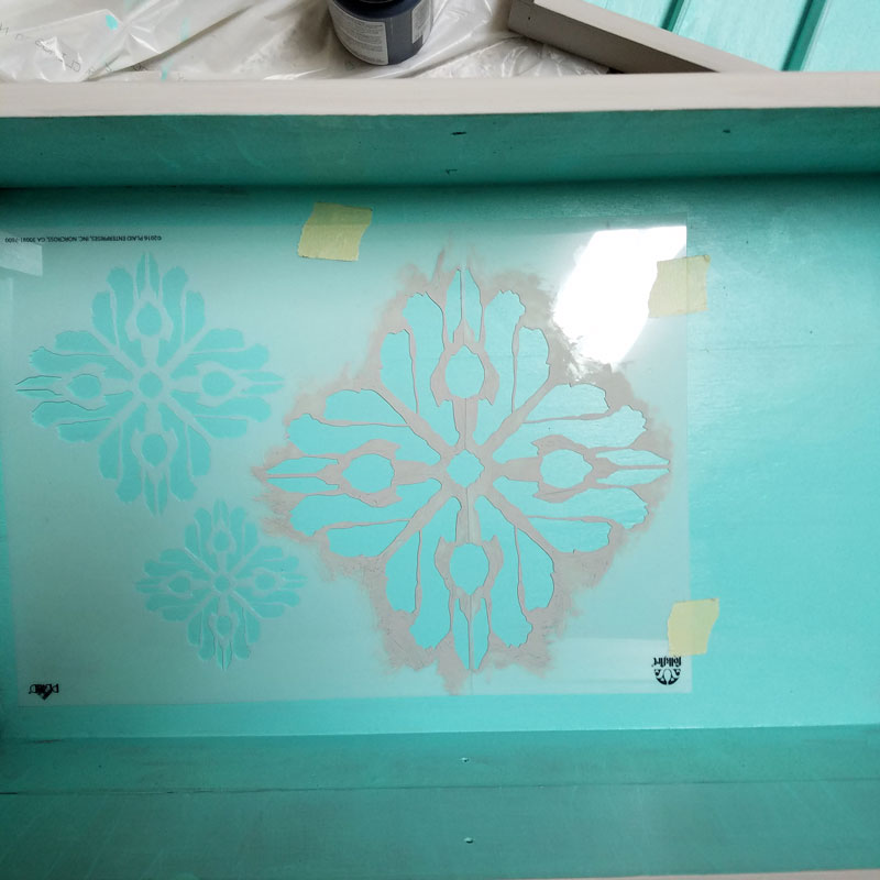 Open up for a cool surprise! Update a vintage sewing box with this cool DIY makeover using stencils. The top says "create" and there are beautiful patterns inside - you simply won't believe that this was a flea market find! One of my favorite thrift store makeovers and trash to treasure DIY projects ever, and perfect for craft room organization.