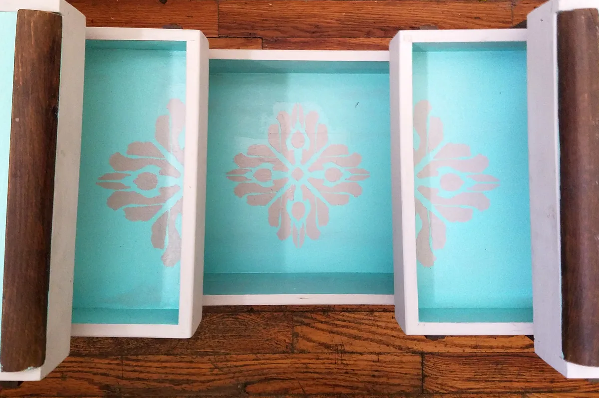Open up for a cool surprise! Update a vintage sewing box with this cool DIY makeover using stencils. The top says "create" and there are beautiful patterns inside - you simply won't believe that this was a flea market find! One of my favorite thrift store makeovers and trash to treasure DIY projects ever, and perfect for craft room organization.