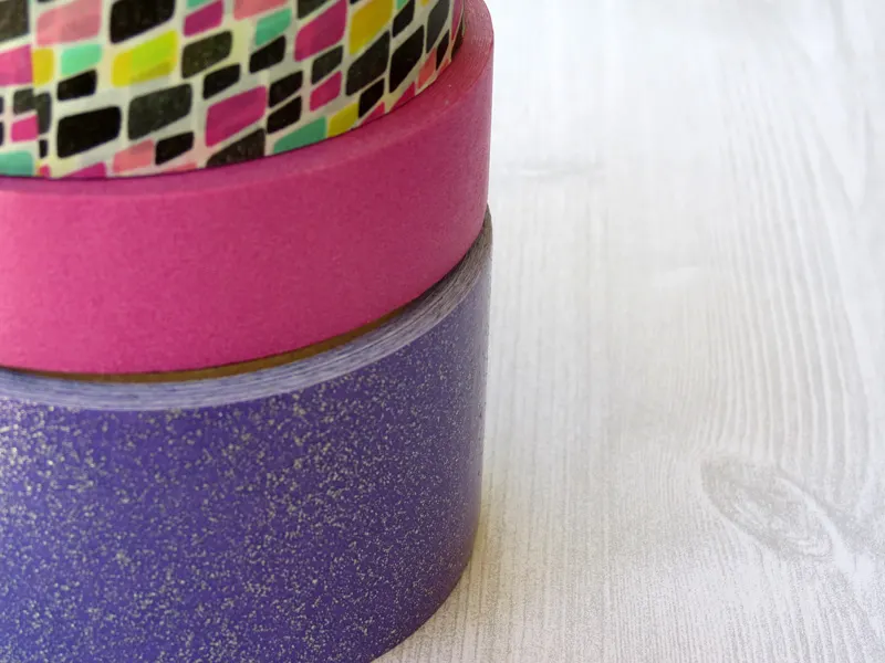 Why washi-tape bomb a hand sanitizer bottle, you ask? These make the most adorable baby shower favors! This washi tape craft is a quick and easy solution for a baby shower craft for a baby boy or girl, and makes a perfect addition to a new mom basket.