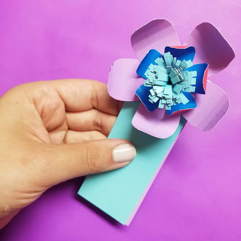 Craft these beautiful paper flower bookmarks - an easy paper craft for kids and teens! You'll love these easy DIY flowers made from cardstock and placing them on a bookmark helps kids love to read and promotes literacy.
