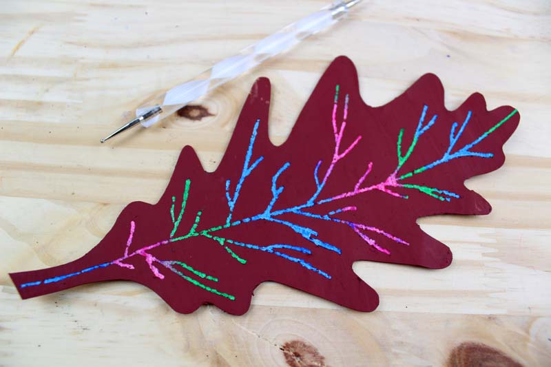 Make this beautiful scratch art fall leaf craft - a beautiful and easy autumn paper craft for kids! Includes a free printable template.