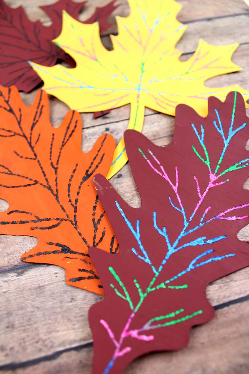 Make this beautiful scratch art fall leaf craft - a beautiful and easy autumn paper craft for kids! Includes a free printable template.