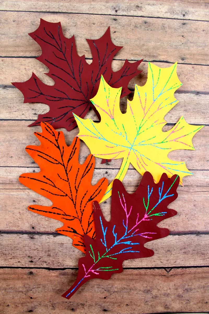 Make this beautiful scratch art fall leaf craft - a beautiful and easy autumn paper craft for kids! Includes a free printable template.