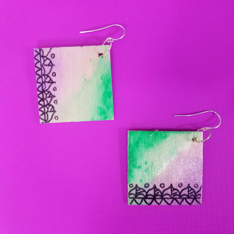 Make these stunning DIY earrings with a watercolor finish and some cool doodles! You'll love this beginner jewelry making project for teens and tweens to enjoy.