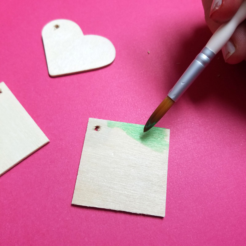 Make these stunning DIY earrings with a watercolor finish and some cool doodles! You'll love this beginner jewelry making project for teens and tweens to enjoy.