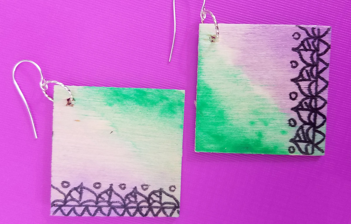 Make these stunning DIY earrings with a watercolor finish and some cool doodles! You'll love this beginner jewelry making project for teens and tweens to enjoy.