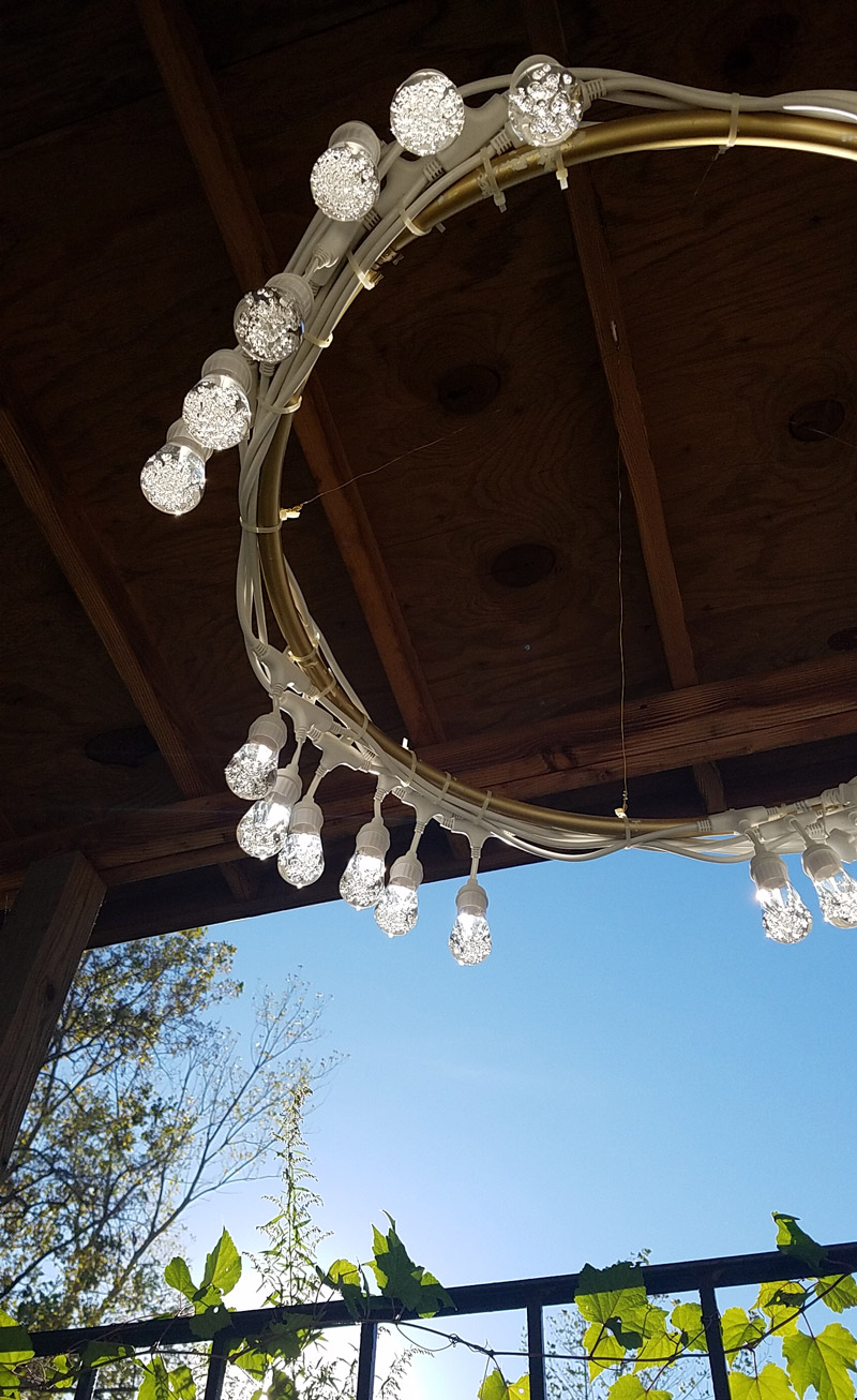 Make a beautiful DIY outdoor chandelier - beautiful and functional patio decor! It's a great way to update your outdoor space.