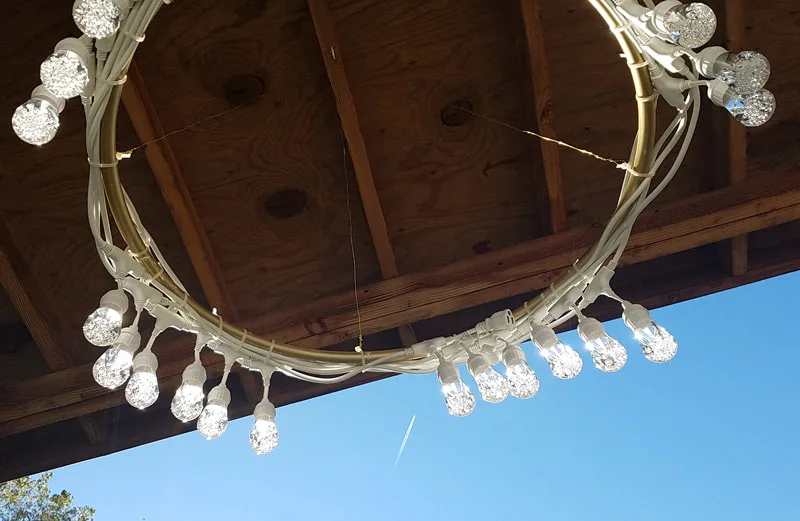 Make a beautiful DIY outdoor chandelier - beautiful and functional patio decor! It's a great way to update your outdoor space.