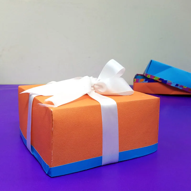 Make this easy DIY gift box from a single sheet of scrapbook paper - isn't that a super cool papercraft for Christmas or Hanukkah - or for gifts any time of year? I love this easy gift wrap idea and paper crafts for kids, teens, tweens, or adults. #papercraft #origami #papercrafts #diy #giftbox