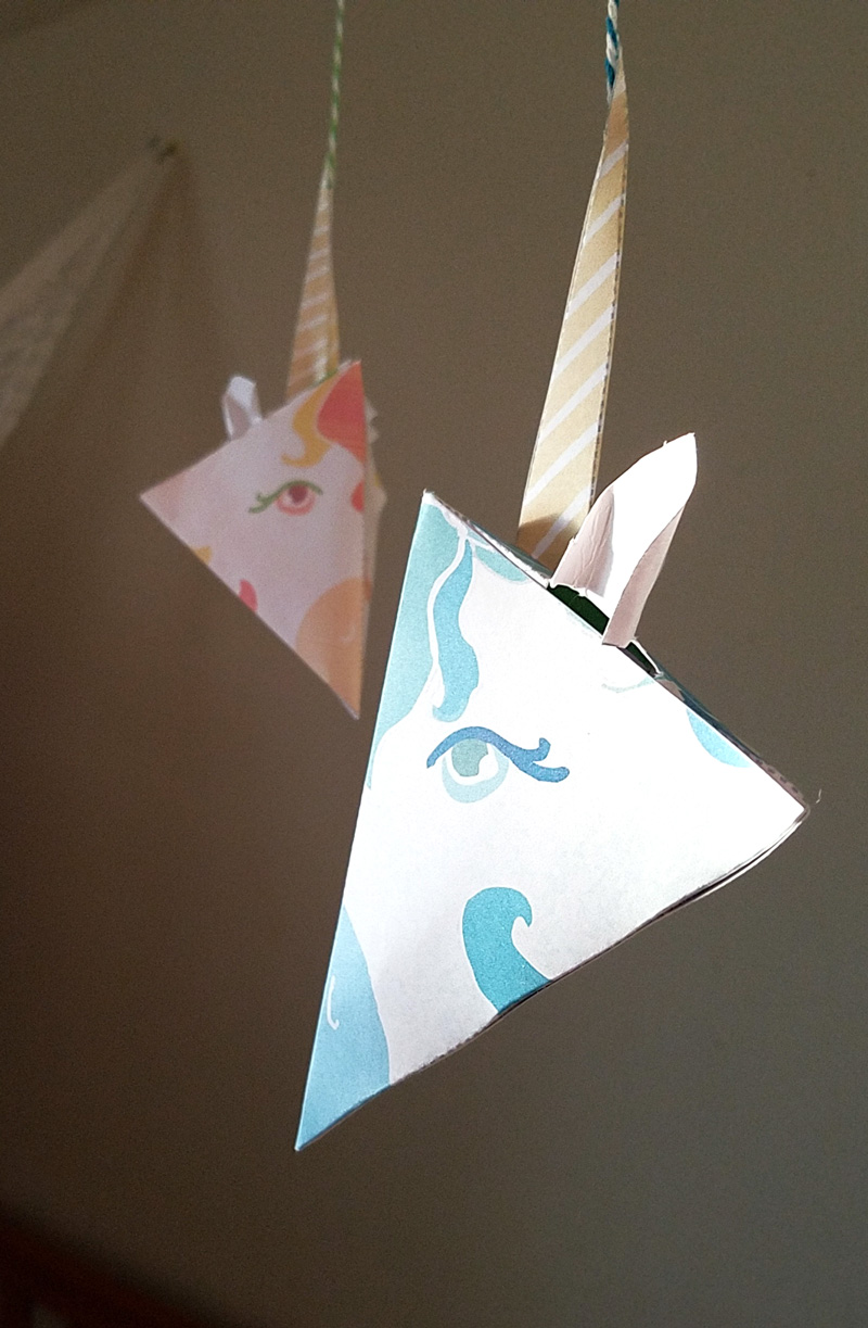 This adorable unicorn paper craft is quite unique - get the free color-in template coloring page for adults (or kids) and then assemble this super easy craft! You can turn it into a baby mobile if you'd like too, for adorable unicorn nursery decor. #unicorns #unicorn #papercraft #papercrafts #coloringpages #adultcoloring