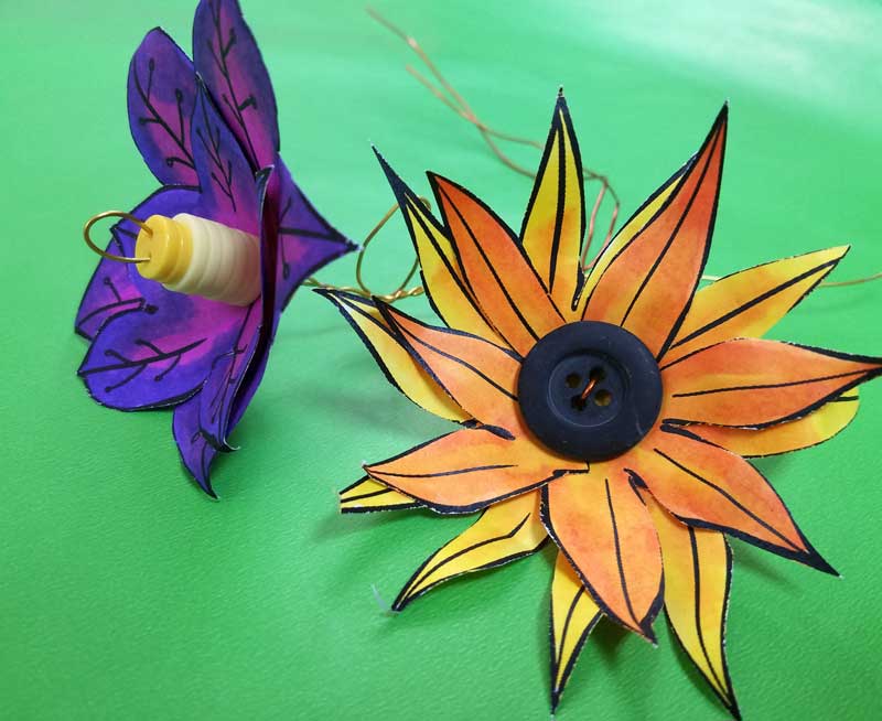 These paper flower templates are too cute for words! What an adorable Spring craft for tweens, teens, or grown-ups! This papercraft is so versatile - use it to set a Spring table, as napkin rings, or put these DIY flowers in a vase. These paper flowers can be made by coloring them in, or using scrapbook paper scraps. #papercraft #spring #freeprintable