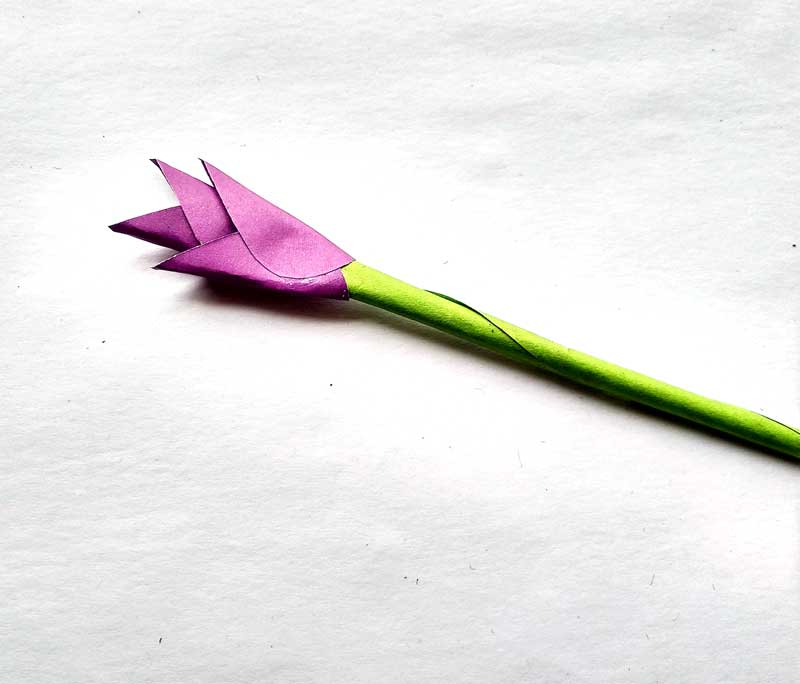 7. Continue gluing on petals folded around your stem, alternating the direction of the opening.