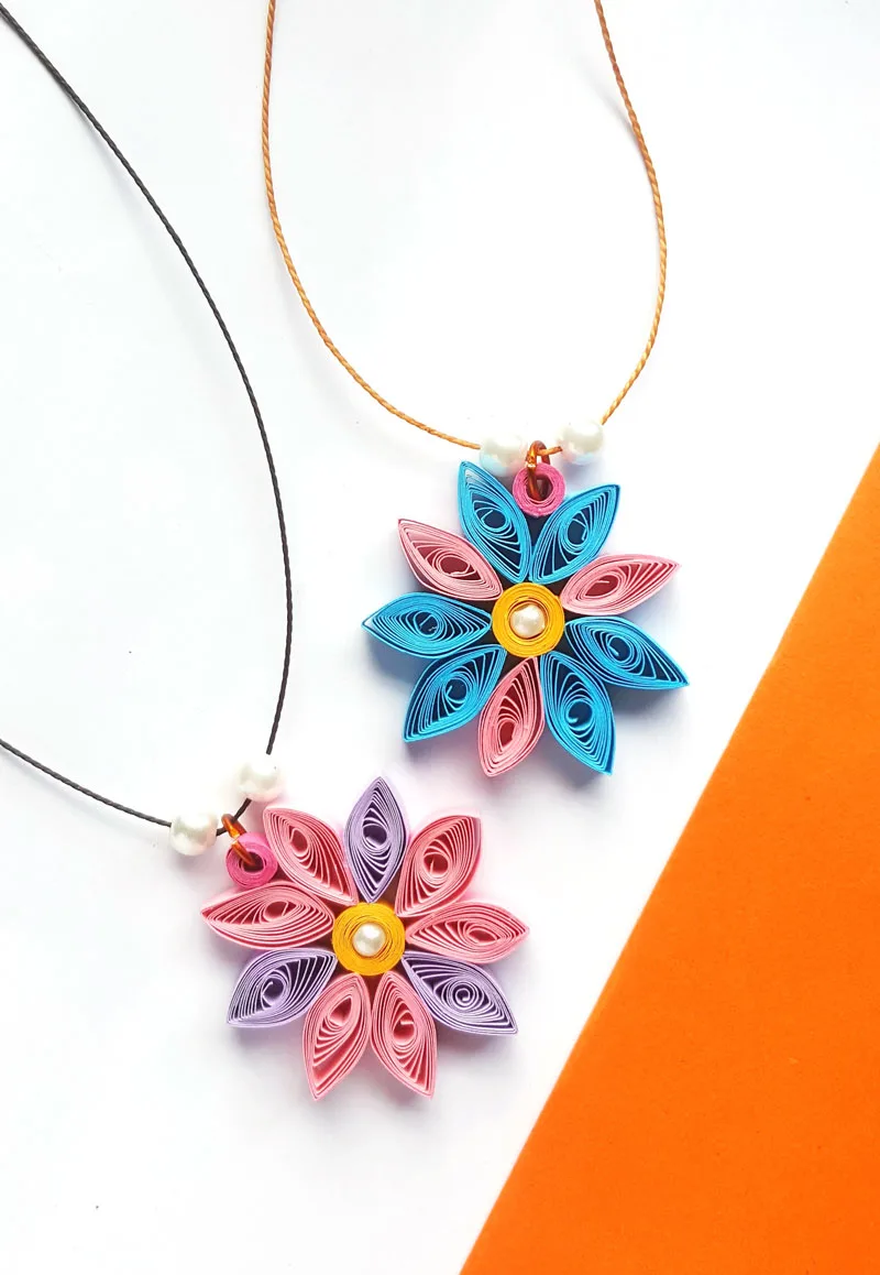 paper quilling flowers are an easy project for beginners and kids - and beautiful DIY jewelry to craft.
