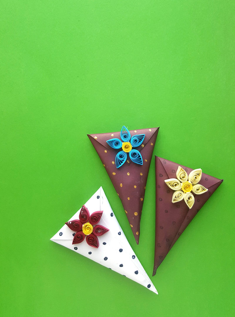 This simple paper quilling gift wrapping idea is perfect for Valentine's day or for gift wrapping at any time of the year. This simple gift wrap trick is a DIY cone gift box made out of regular scrapbook or crafting paper.