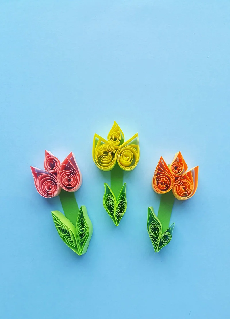 Click to learn how to make these gorgeous paper quilling tulips -a fun and easy beginner quilled paper flower tutorial and spring crafts for teens!
