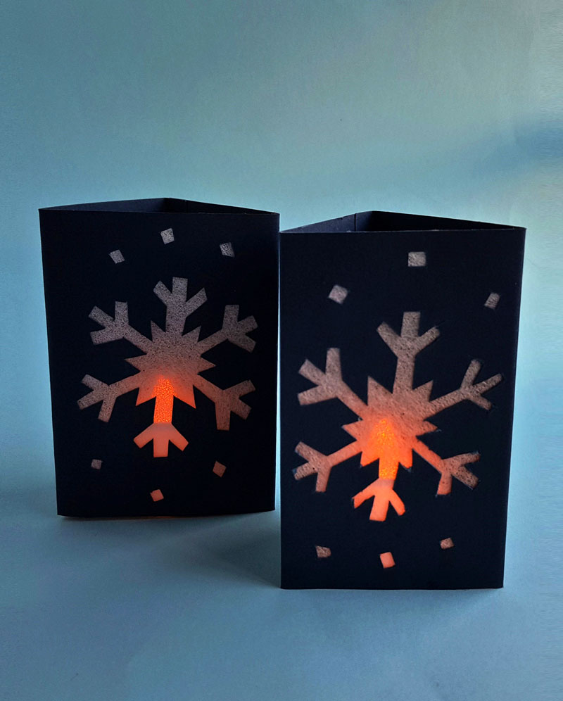 Craft an easy DIY snowflake lantern using paper! This fun paper lantern craft makes gorgeous christmas decor and is a fun paper craft for kids, or a beginner paper cutting craft for anyone