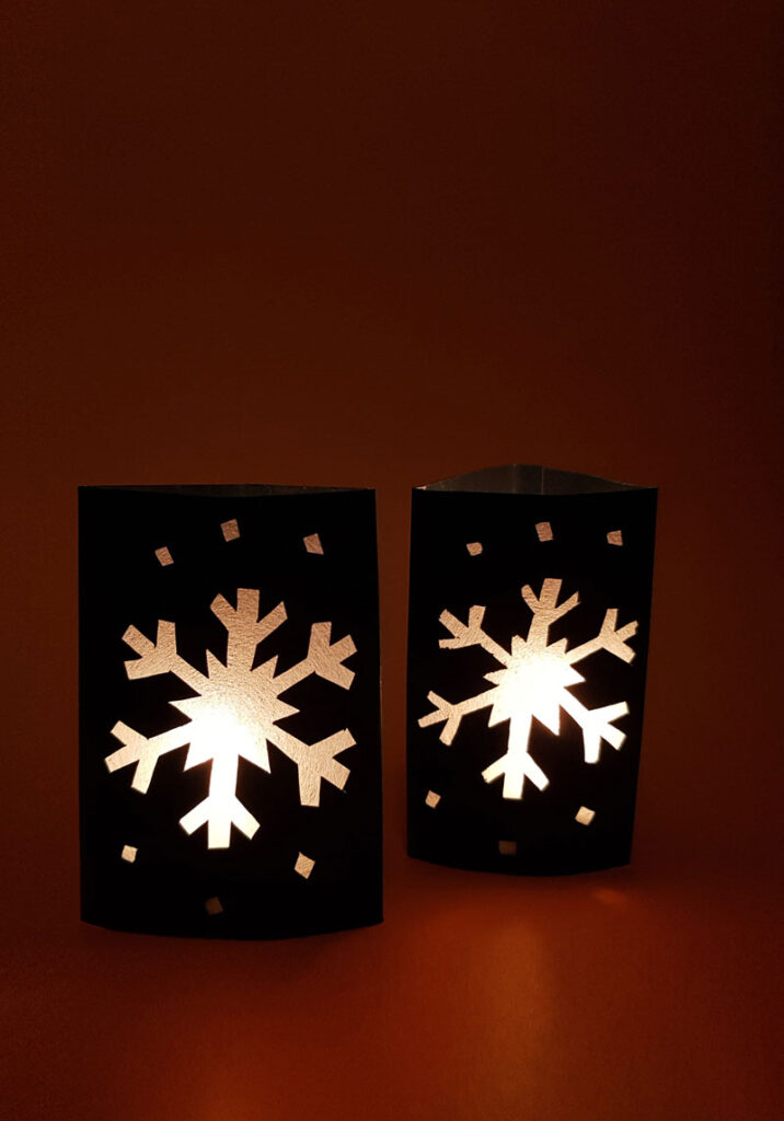 Craft an easy DIY snowflake lantern using paper! This fun paper lantern craft makes gorgeous christmas decor and is a fun paper craft for kids, or a beginner paper cutting craft for anyone