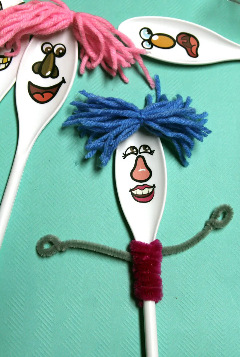 Final step of making spoon puppets is adding chenille stem hands and outfits 
