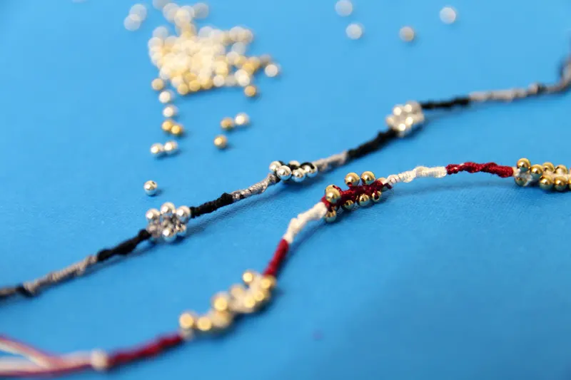 easy beaded friendship bracelets photographed with bokeh on a blue background