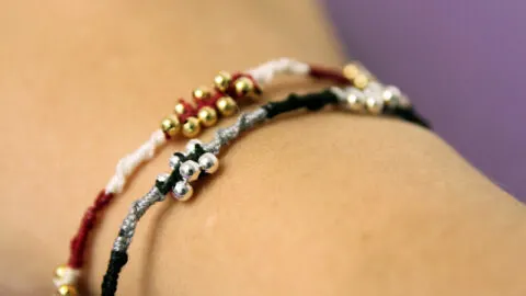 photo showing a hand modeling easy beaded friendship bracelets
