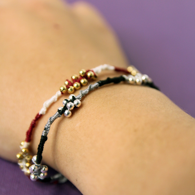 photo showing a hand modeling easy beaded friendship bracelets