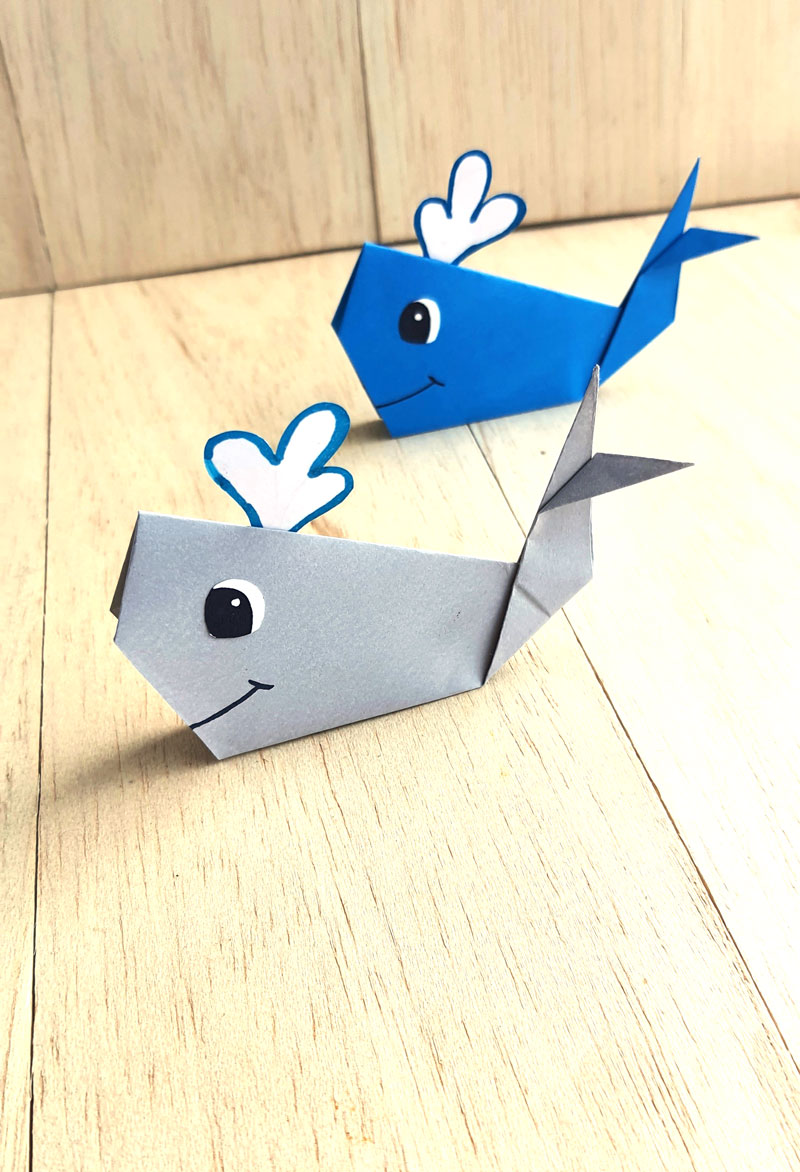 vertical image of easy origami whales at an angle